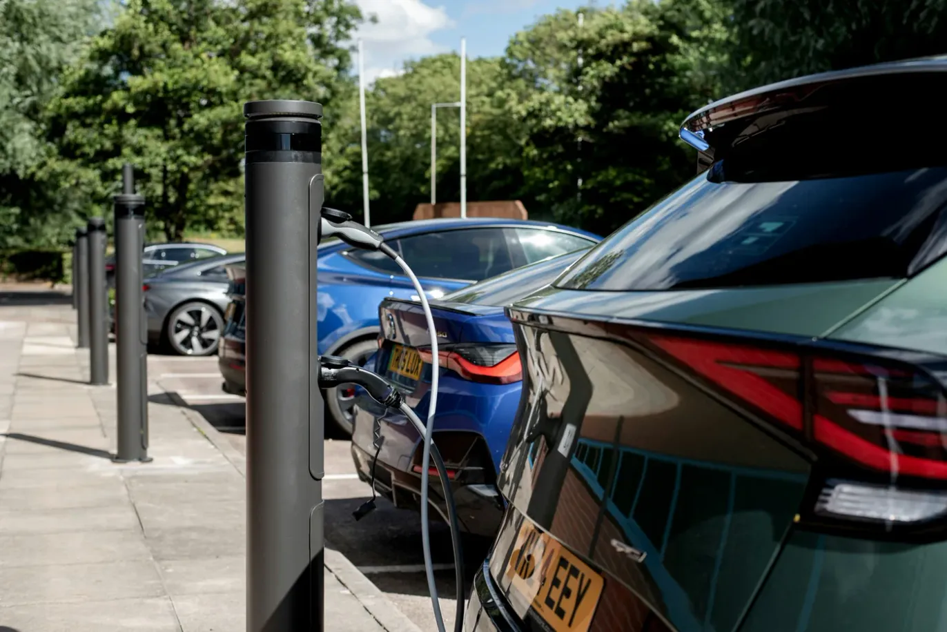Electric cars plugged into charge posts in a UK car park