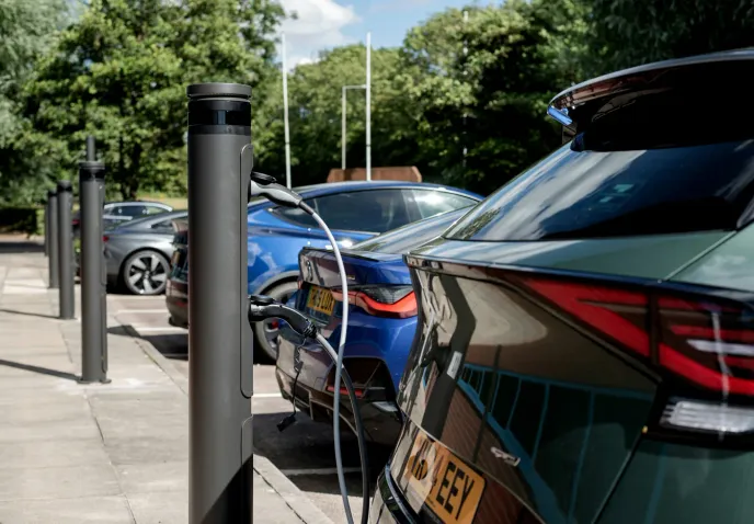 Electric cars plugged into charge posts in a UK car park