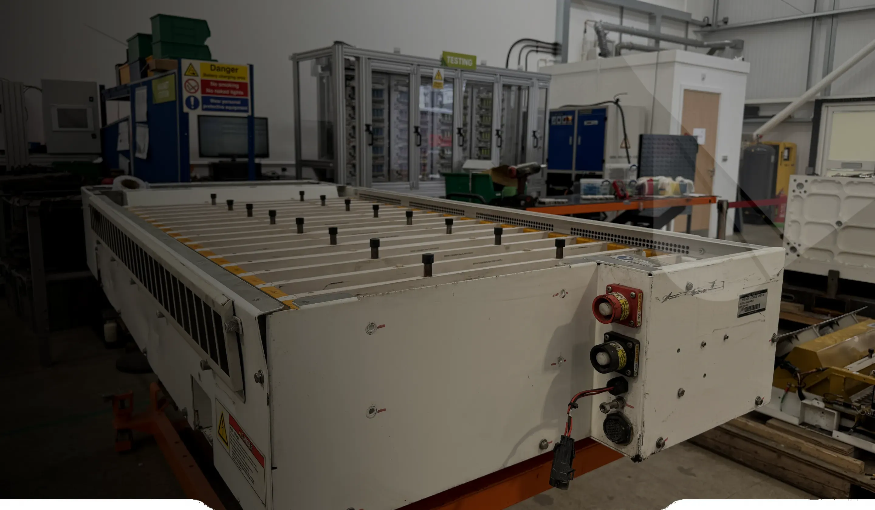 An end-of-life EV battery pack on a lift table at GTI, ready for disassembly